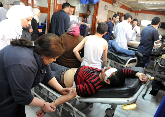 A handout picture released by the Syrian Arab News Agency (SANA) shows wounded people being treated in the emergency room of a hospital following an alleged mortar attack that hit the Baramkeh district of Damascus on March 26, 2013.(AFP Photo / SANA)