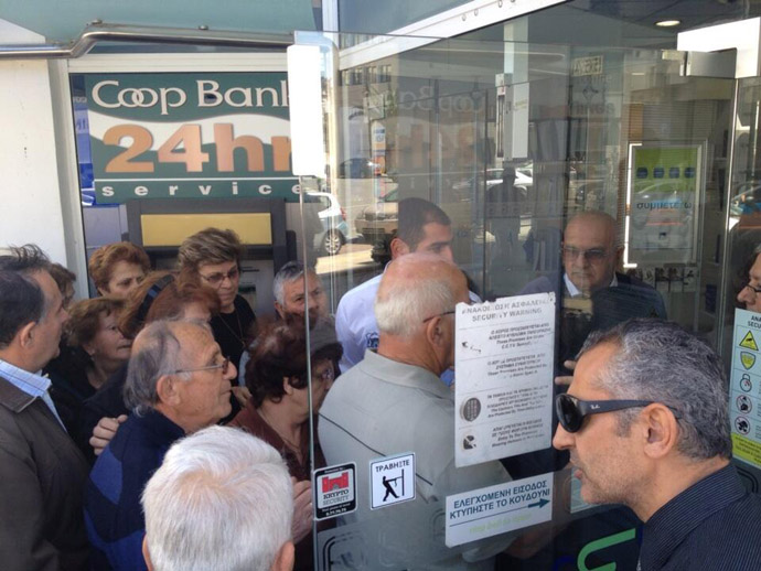 Banks in Cyprus open at 12:00 GST. People crowd the doors to access their savings for the first time in twelve days (Image from Twitter/@willgoodbody)