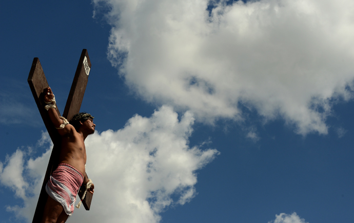 A penintent is nailed to a cross during the reenactment of crucifixion on Good Friday in the village of San Juan, San Fernando City, north of Manila on March 29, 2013 (AFP Photo / Noel Celis)