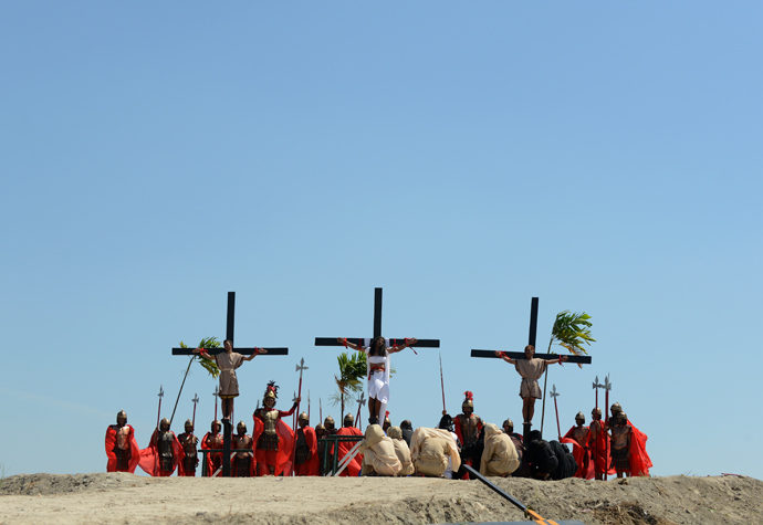 Philippine Christian devotee Ruben Enaje (C), is nailed to a cross during a re-enactment of the crucifixion of Jesus Christ on Good Friday in San Fernando City, Pampanga province, north of Manila on March 29, 2013 (AFP Photo / Noel Celis)