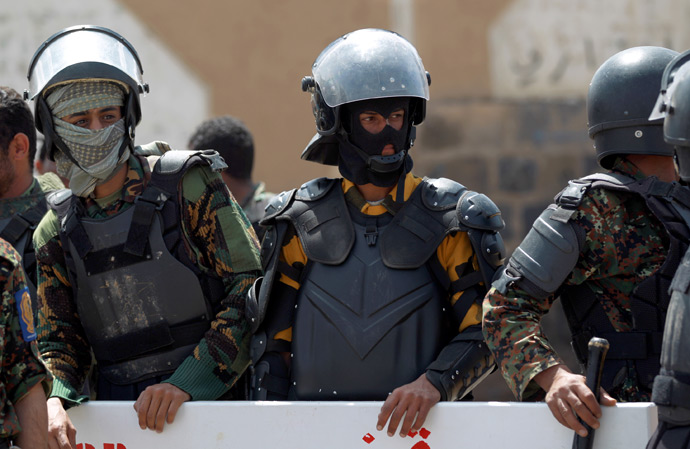 Riot police secure the vicinity of the U.S. embassy, during a protest by relatives of Yemenis detained at the US detention center "Camp Delta" at the US Naval Base in Guantanamo Bay, Cuba, during a protest to demand their release, in Sanaa, on April 1, 2013 (AFP Photo / Mohammed Huwais)