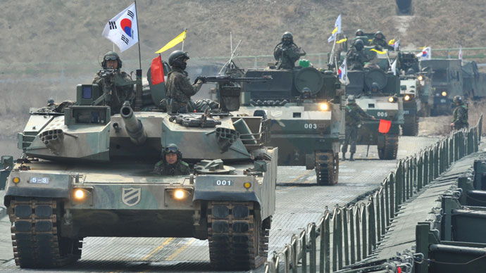 South Korean K-1 tanks move over a temporary bridge during a river-crossing military drill in Hwacheon near the border with North Korea on April 1, 2013.(AFP Photo / Kim Jae-Hwan)