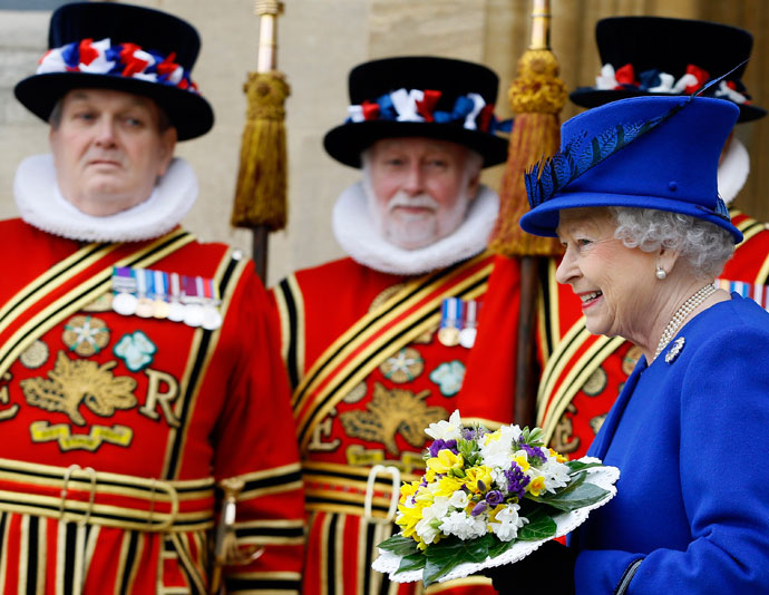 Britain's Queen Elizabeth II (R) smiles as she walks past Yeomen of the Guard after attending the Maundy service at Christ Church Cathedral in Oxford, on March 28, 2013.(AFP Photo / Kirsty Wigglesworth)