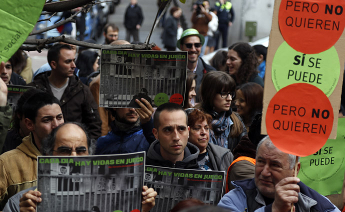 Members of the Mortgage Victims' Platform (PAH) hold placards during a protest in Madrid April 3, 2013. (Reuters)