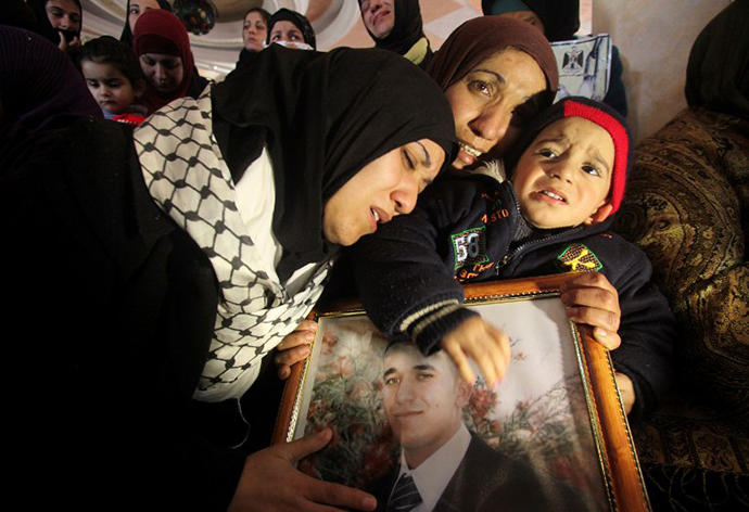 The sisters of Arafat Jaradat (picture), a Palestinian inmate who died in an Israeli prison, mourn their brother's death. (AFP Photo / Hazem Bader)