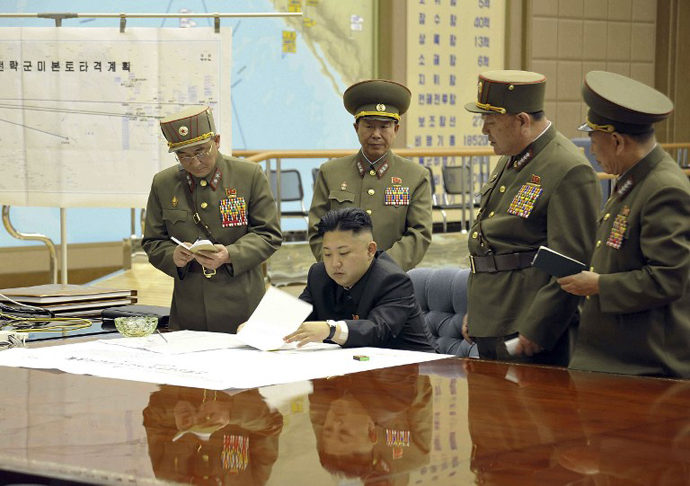 This file photo taken and released by North Korea's official Korean Central News Agency (KCNA) shows, according to KCNA, North Korean leader Kim Jong-Un discussing the strike plan with North Korean officers. (AFP Photo / KCNA)