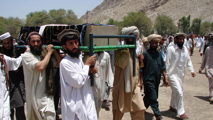 Pakistani tribesmen carry the coffin of a person allegedly killed in a US drone attack, claiming that innocent civilians were killed during a June 15 strike in the North Waziristan village of Tapi, 10 kilometers away from Miranshah.(AFP Photo / Thir Khan)
