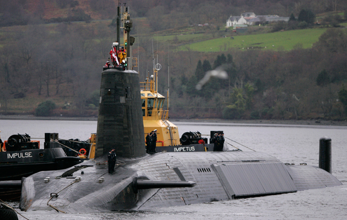 Crew from HMS Vengeance, a British Royal Navy Vanguard class Trident Ballistic Missile Submarine, stand on their vessel as they return along the Clyde river to the Faslane naval base near Glasgow, Scotland (Reuters / David Moir)