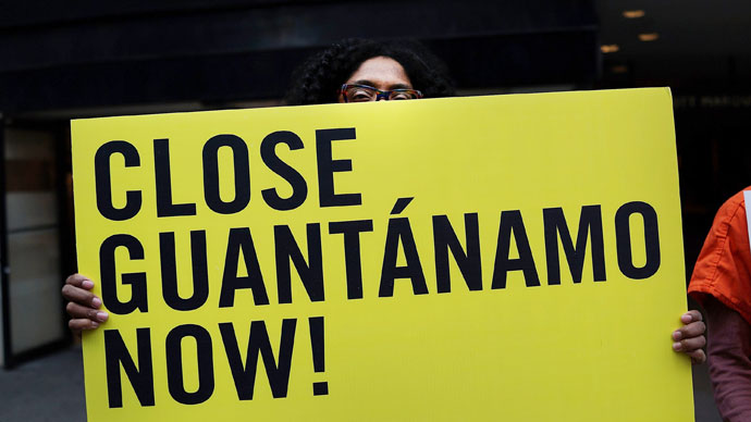 A woman holds up a sign while participating in a nationwide "Day of Action to Close Guantanamo & End Indefinite Detention" on April 11, 2013.(AFP Photo / Spencer Platt)