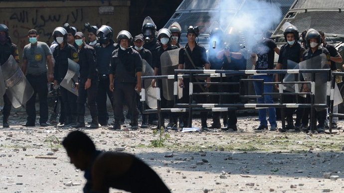 An Egyptian riot police officer fires tear gas towards protesters. (AFP Photo / Khaled Desouki)