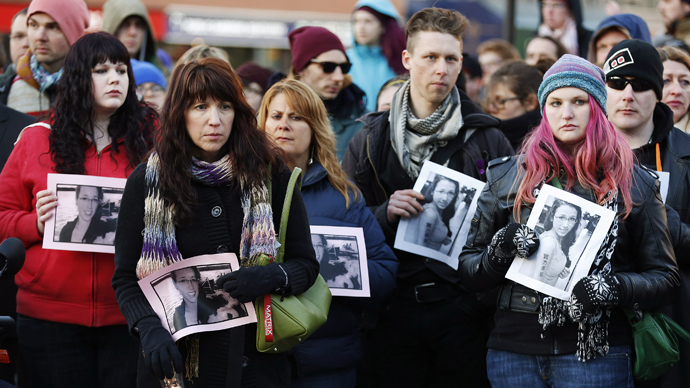 People hold photographs of 17-year-old Rehtaeh Parsons during a memorial vigil at Victoria Park in Halifax, Nova Scotia April 11, 2013. (Reuters / Paul Darrow)