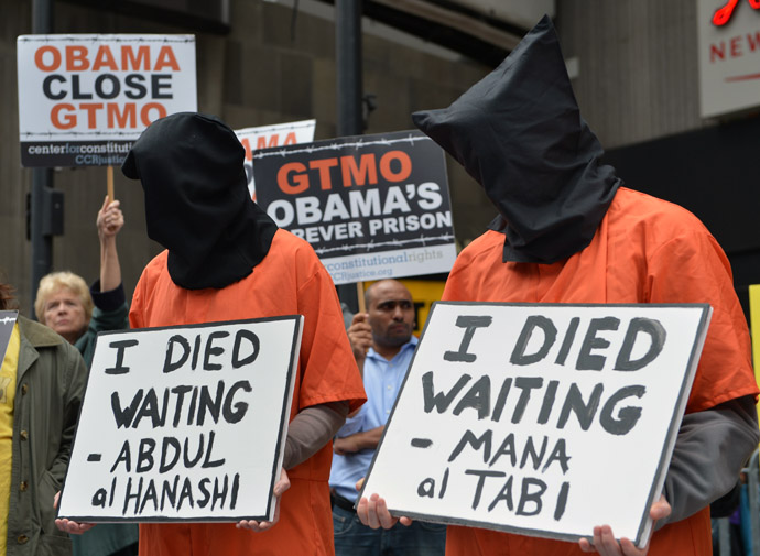 People dress in orange jumpsuits and black hoods as activists demand the closing of the US military's detention facility in Guantanamo during a protest, part of the Nationwide for Guantanamo Day of Action, April 11, 2013 in New York's Times Square. (AFP Photo/Stan Honda)