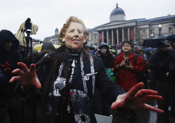 A woman wearing a mask representing late former British prime minister Margaret Thatcher poses for photographers at a party to celebrate Thatcher's death at Trafalgar Square in central London April 13, 2013. (Reuters)