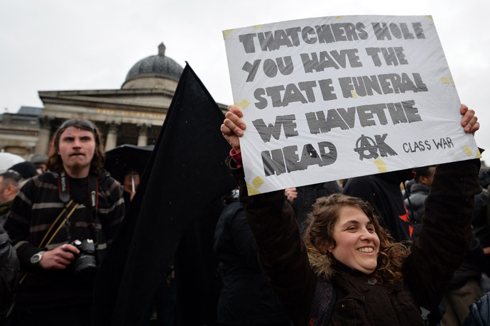 A woman holds up an anti-Thatcher placard during a rally to celebrate her death in Trafalgar Square, central London, on April 13, 2013. (AFP Photo)