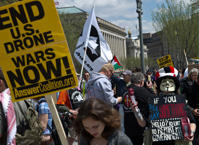 Protesters hold signs and chant slogans outside the White House in Washington on April 13, 2013 during a demonstration against the use of dones against Islamic militants and other perceived enemies of the US around the world. (AFP Photo/Nicholas Kamm)