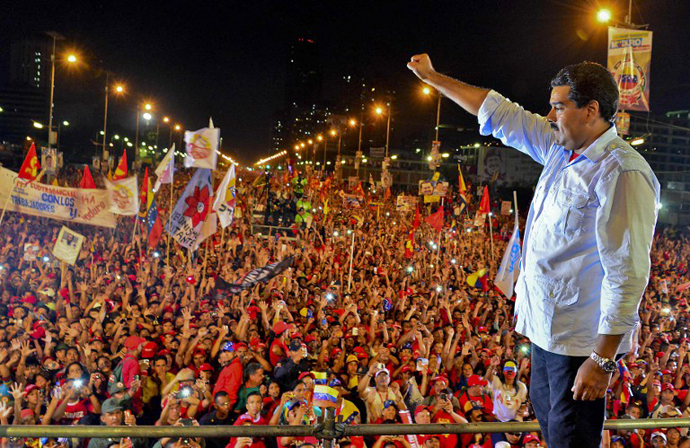Venezuelan acting President and presidential candidate Nicolas Maduro gestures during his closing campaign rally in Caracas on April 11, 2013. (AFP Photo / Luis Acosta)