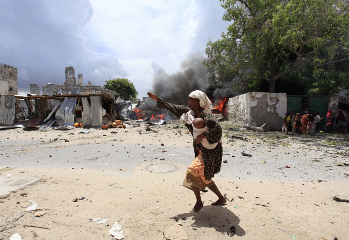 A Somali woman runs to safety near the scene of a blast in Mogadishu April 14, 2013. (Reuters / Feisal Omar)