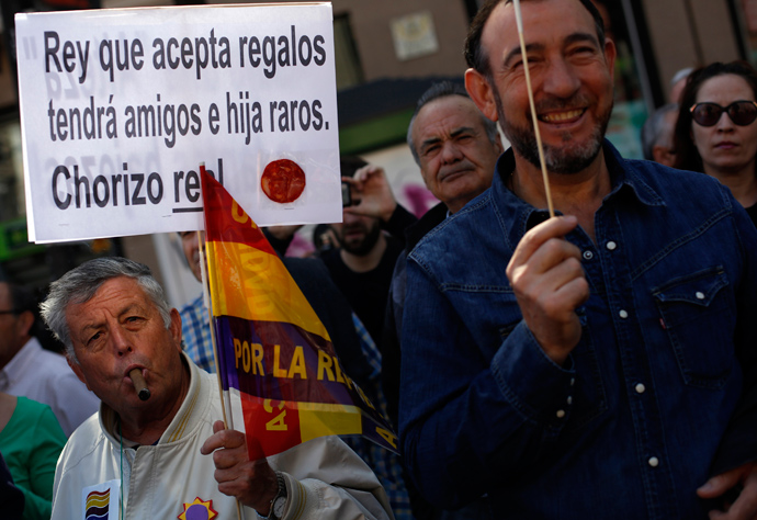 A man holds a placard that has a slice of chorizo sausage during a rally to mark the 82nd anniversary of Spain's Second Republic in Madrid April 14, 2013. The placard reads, " King who accepts gifts will have strange friends and daughters. Royal chorizo!!!" Chorizo is slang for thief in Spanish (Reuters / Susana Vera) 