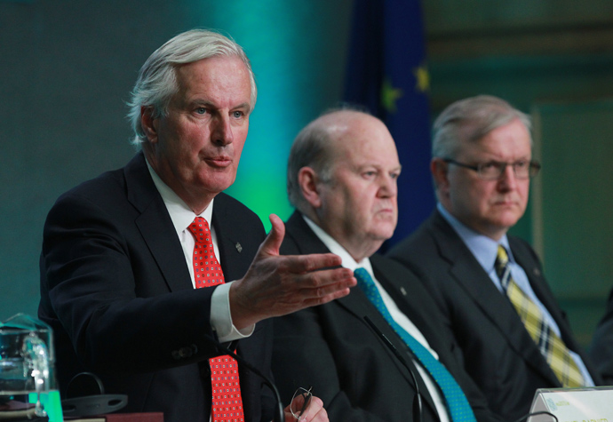 EU commissioner for Internal Market and Services Michel Barnier (L) speaks to journalists as Irish Finance Minister Michael Noonan (C) and European Union Commissioner for Economic and Monetary Affairs Olli Rehn (R) look on during a press conference at the informal meeting of Economic and Financial Affairs Council (ECOFIN) ministers at Dublin Castle in Dublin, Ireland on April 12, 2013 (AFP Photo / Peter Muhly) 