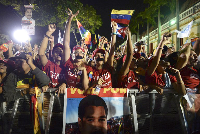 Supporters of Venezuelan acting President Nicolas Maduro celebrate after knowing the election results in Caracas on April 14, 2013. (AFP Photo / Juan Barreto)