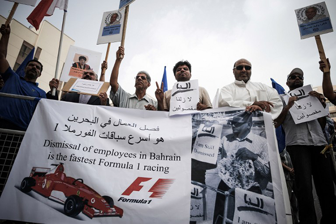 Bahraini protesters hold up a placards during a demonstration in the capital Manama, on April 13, 2013. (AFP Photo / Mohammed Al-Shaikh)