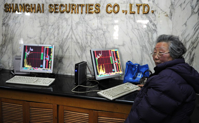 An elderly investor looks at stock prices at a securities exchange in Shanghai on February 22, 2013. (AFP Photo / Peter Parks)
