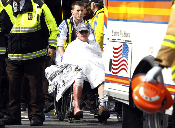 A runner in a wheelchair is taken from a triage tent after explosions went off at the 117th Boston Marathon in Boston, Massachusetts April 15, 2013 (Reuters / Jessica Rinaldi) 