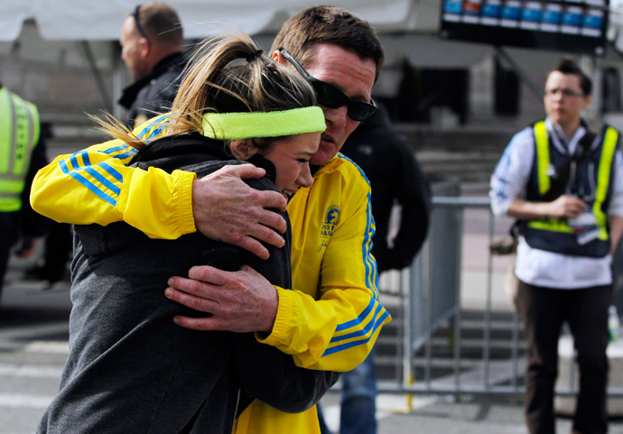 A woman is comforted by a man near a triage tent set up for the Boston Marathon after explosions went off at the 117th Boston Marathon in Boston, Massachusetts April 15, 2013 (Reuters / Jessica Rinaldi) 