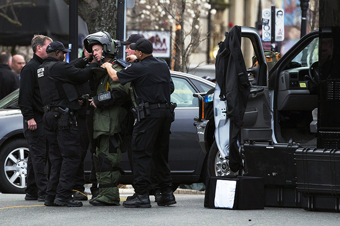 A law enforcement bomb technician is helped to put on his protective suit, before he set off a controlled detonation of a suspicious object during a search for a suspect in the Boston Marathon bombing, in Watertown, Massachusetts April 19, 2013. (Reuters / Lucas Jackson)