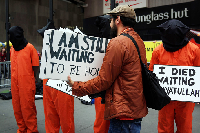 Activists in Times Square, dressed in orange prison jumpsuits, participate in a nationwide "Day of Action to Close Guantanamo & End Indefinite Detention" on April 11, 2013 in New York City (Reuters / Spencer Platt)