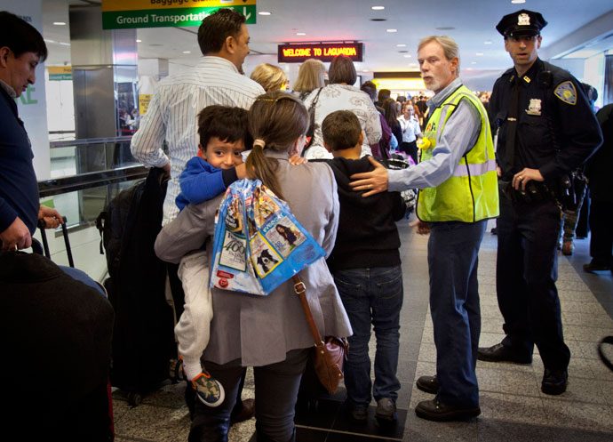 American Airlines employee Paul Reinold helps to expedite people though the security line at LaGuardia airport after it was shut down for a time due to a security scare in New York, April 16, 2013.(Reuters / Carlo Allegri)