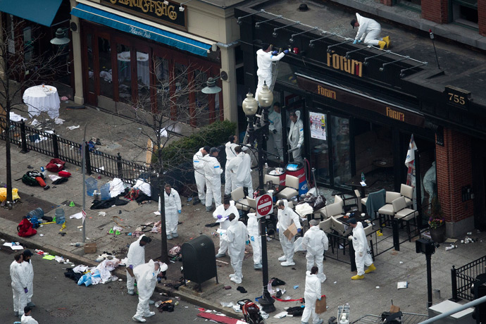 Officials take crime scene photos a day after two explosions hit the Boston Marathon in Boston, Massachusetts April 16, 2013 (Reuters / Shannon Stapleton)