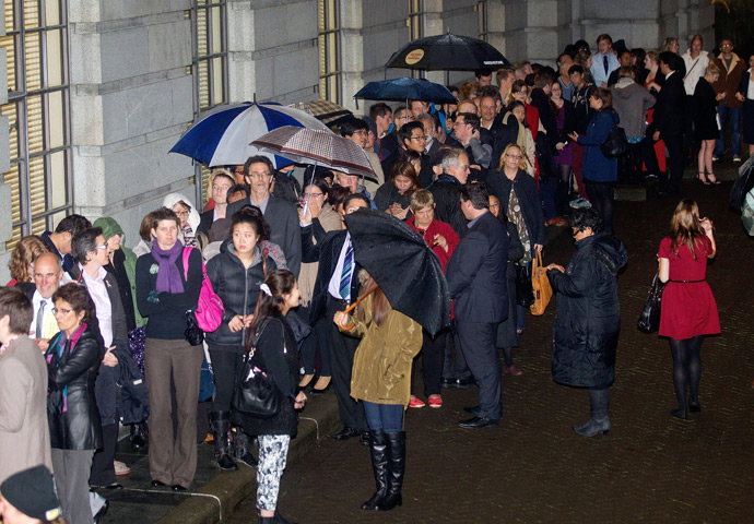 Hundreds of people wait outside the parliament building in Wellington on April 17, 2013 for a place in the public gallery to see the chamber vote on a bill amending the 1955 Marriage Act to describe matrimony as a union of two people regardless of their sex, sexuality or how they choose to identify their gender (AFP Photo / Marty Malville)