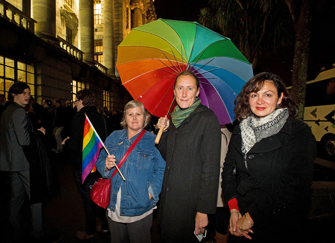 Gay-rights supporters wait outside the parliament building in Wellington on April 17, 2013 for a place in the public gallery to see the chamber vote on a bill amending the 1955 Marriage Act to describe matrimony as a union of two people regardless of their sex, sexuality or how they choose to identify their gender (AFP Photo / Marty Malville)