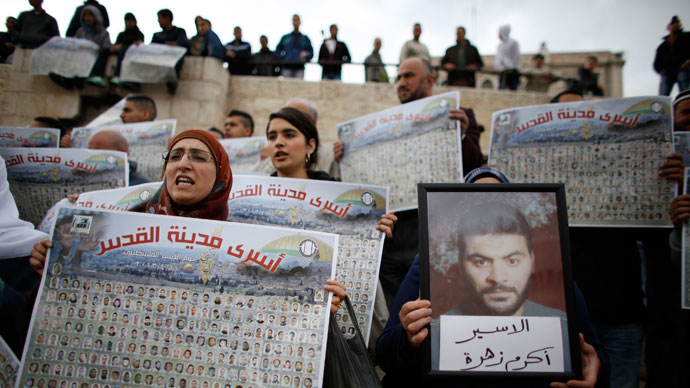 Palestinians hold posters with pictures of Palestinian prisoners during a protest marking "Palestinian Prisoners Day" at Damascus Gate in Jerusalem's Old City April 17, 2013.(Reuters / Ammar Awad)