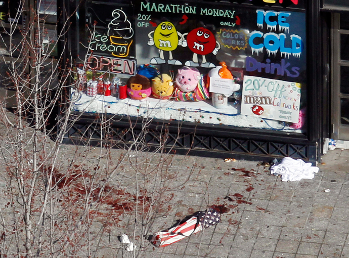 Blood in seen on the sidewalk in front of a candy store advertising a Marathon Monday sale a day after two explosions at the Boston Marathon in Boston, Massachusetts April 16, 2013 (Reuters / Jessica Rinaldi)