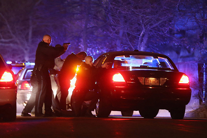 Police with guns drawn search for a suspect on April 19, 2013 in Watertown, Massachusetts. (AFP Photo / Mario Tama)