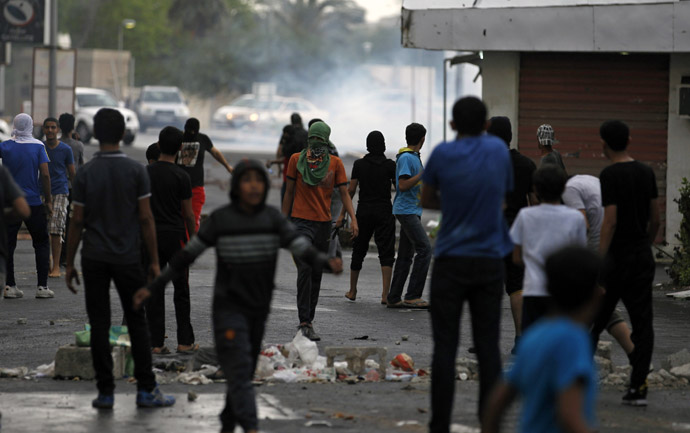 Anti-government protesters stand in front of a teargas cloud fired by riot police during a demonstration in the village of Diraz west of Manama April 18, 2013, ahead of this weekend's Formula One Grand Prix. Bahrain human rights activist Nabeel Rajab (Reuters/Hamad I Mohammed)