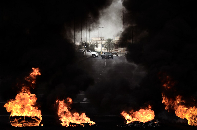 Tyres placed on the road by anti-regime protestors are burning during clashes with riot police following a protest against the arrival of Bahrain Formula One Grand Prix on April 18, 2013 in the village of Diraz, west of Manama. (AFP Photo / Mohammed Al-Shaikh)