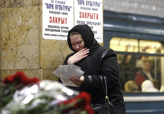 A woman is standing at the Park Kultury station where people keep on bringing flowers in memoriam of the 29th March 2010 blast victims. (RIA Novosti / Ruslan Krivobok)