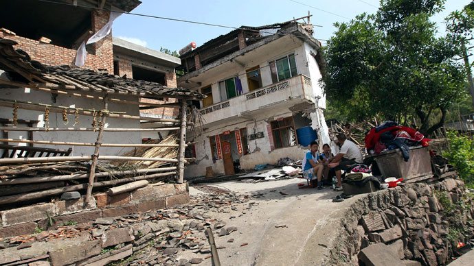People rest outside damaged houses after a strong 6.6 magnitude earthquake hit, at Longmen village, Lushan county, Ya'an, Sichuan province April 20, 2013.(Reuters / Stringer)