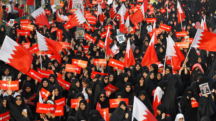 Protesters holding banners that read "I Love Bahrain" participate with Bahraini flags during an anti-government rally organised by main opposition group Al Wefaq in Budaiya, west of Manama April 19, 2013.(Reuters / Hamad I Mohammed)
