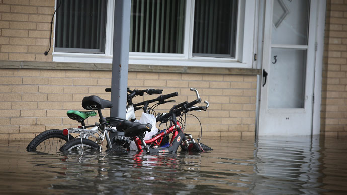 Bicycles sit in floodwater outside an apartment building April 19, 2013 in Des Plaines, Illinois.(AFP Photo / Scott Olson)
