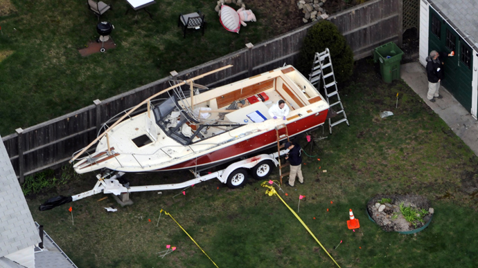 Investigators work around the boat where Dzhokhar A. Tsarnaev was found hiding after a massive manhunt, in the backyard of a Franklin Street home, in an aerial view April 20, 2013 in Watertown, Massachusetts (AFP Photo / Darren McCollester)