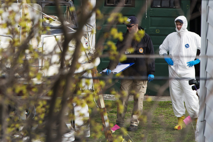 Members of the FBI Evidence Recovery Team inspect the boat where Boston Marathon bombing suspect Dzhokhar Tsarnaev was hiding at 67 Franklin St. in Watertown, Massachusetts, April 20, 2013. (Reuters / Lucas Jackson)