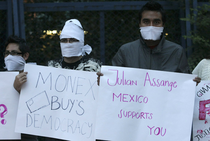 Supporters of WikiLeaks founder Julian Assange hold placards during a protest outside the U.S. embassy in Mexico City (Reuters)