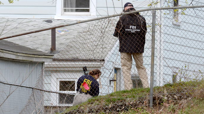 FBI investigators search the shooting scene near the boat where bombing suspect was hiding from police on Franklin Street on April 20, 2013 in Watertown, Massachusetts. (Kevork Djansezian/Getty Images/AFP)