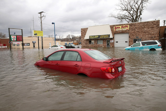 A car is stranded in the middle of a downtown street after being overcome by floodwater April 19, 2013 in Des Plaines, Illinois. (Scott Olson/Getty Images/AFP)