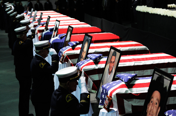 Firefighters salute in front of caskets and pictures of their colleagues during a memorial service at Baylor University in Waco, Texas, on April 25, 2013 for the firefighters who were killed in a huge blast at a Texas fertilizer plant last week (AFP Photo / Jewel Samad)