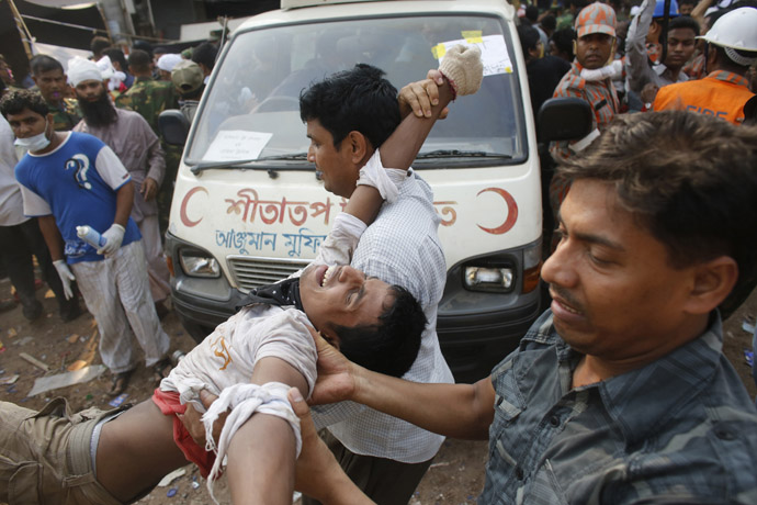 Rescue workers carry a garment worker alive from the rubble of the collapsed Rana Plaza building, in Savar, 30 km (19 miles) outside Dhaka April 26, 2013. (Reuters/Andrew Biraj)